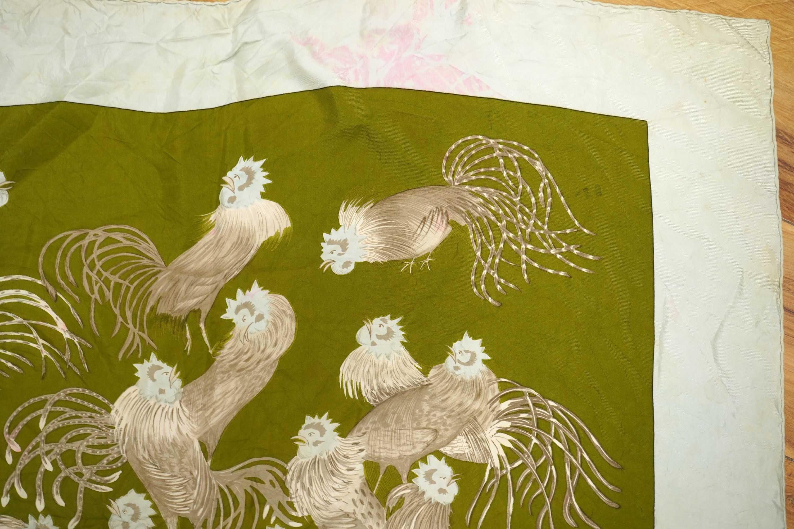 A collection of three Hermes silk scarves and a Chanel monogram example